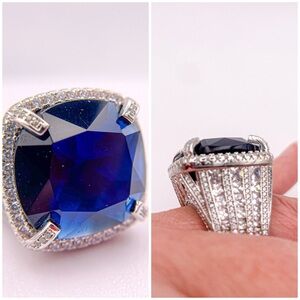 Chunky silver toned iced out dark blue sapphire colored cocktail ring